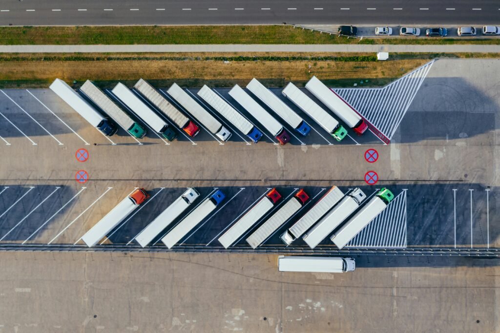 multiple trucks sitting at a warehouse